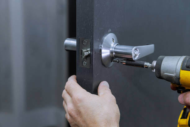 Installing Lock Handles On Room Doors With Screwdriver By Carpenter Installing Lock Handles On Commercial Doors With Screwdriver. For Dc Locks Installation