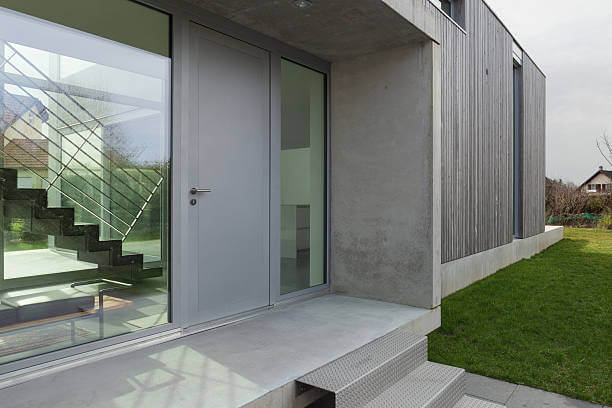 Entrance Of A Modern House In Concrete And Wood, Outside Entrance Of A Modern House In Concrete With Steel Door. For Steel Door Installation And Repair In Dc, Trust King Door And Lock